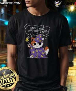 Alt Text: Cute antisocial cat t-shirt featuring the phrase A Spell A Day Keeps Idiots Away in playful typography.