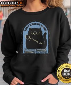 Cute cat on a 'Don't Touch My Books' sweatshirt, showcasing a playful feline design perfect for cat lovers.