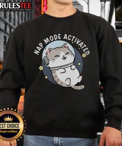 Adorable cat napping in a cozy 'Cute Cat Nap Mode Activated Zero-Gravity Snooze Sweatshirt' on a soft bed.