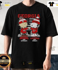 Charlie Brown and Snoopy in Georgia Bulldogs and Atlanta Falcons shirts against a skyline background. Perfect game day tee!