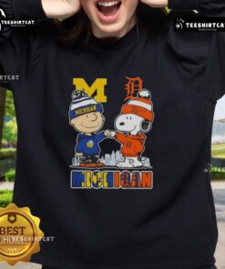 Cute Snoopy and Charlie Brown Michigan Sports sweatshirt featuring Wolverines and Detroit Tigers skyline design.