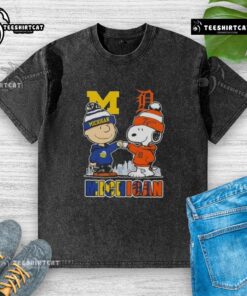 Cute Snoopy and Charlie Brown in Michigan sports Wolverines and Detroit Tigers skyline washed t-shirt design.