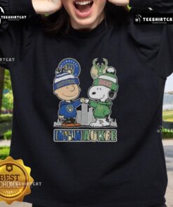 Cute Snoopy and Charlie Brown sweatshirt featuring Milwaukee skyline, supporting Brewers and Bucks sports teams.