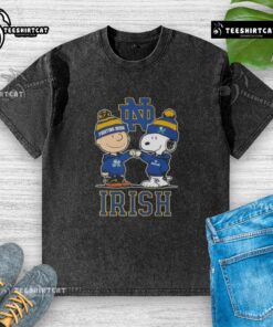 Alt Text: Cute Snoopy and Charlie Brown Notre Dame Fighting Irish football skyline washed t-shirt design featuring iconic characters.
