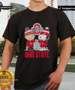 Alt Text: Cute Snoopy and Charlie Brown in Ohio State Buckeyes football gear on a skyline t-shirt design.