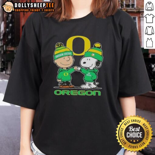 Cute Snoopy and Charlie Brown Oregon Ducks football skyline graphic on a ladies tee shirt, perfect for fans.