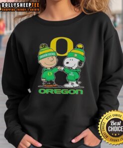 Alt Text: Cute Snoopy and Charlie Brown in Oregon Ducks football sweatshirt against a skyline backdrop. Perfect for fans!