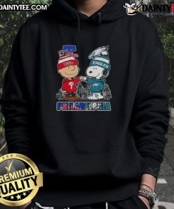 Cute Snoopy and Charlie Brown hoodie featuring Philadelphia sports teams Phillies and Eagles skyline design.