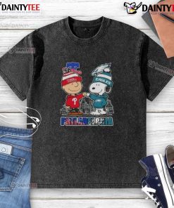 Alt Text: Cute Snoopy and Charlie Brown in Philadelphia sports Phillies and Eagles skyline washed t-shirt design