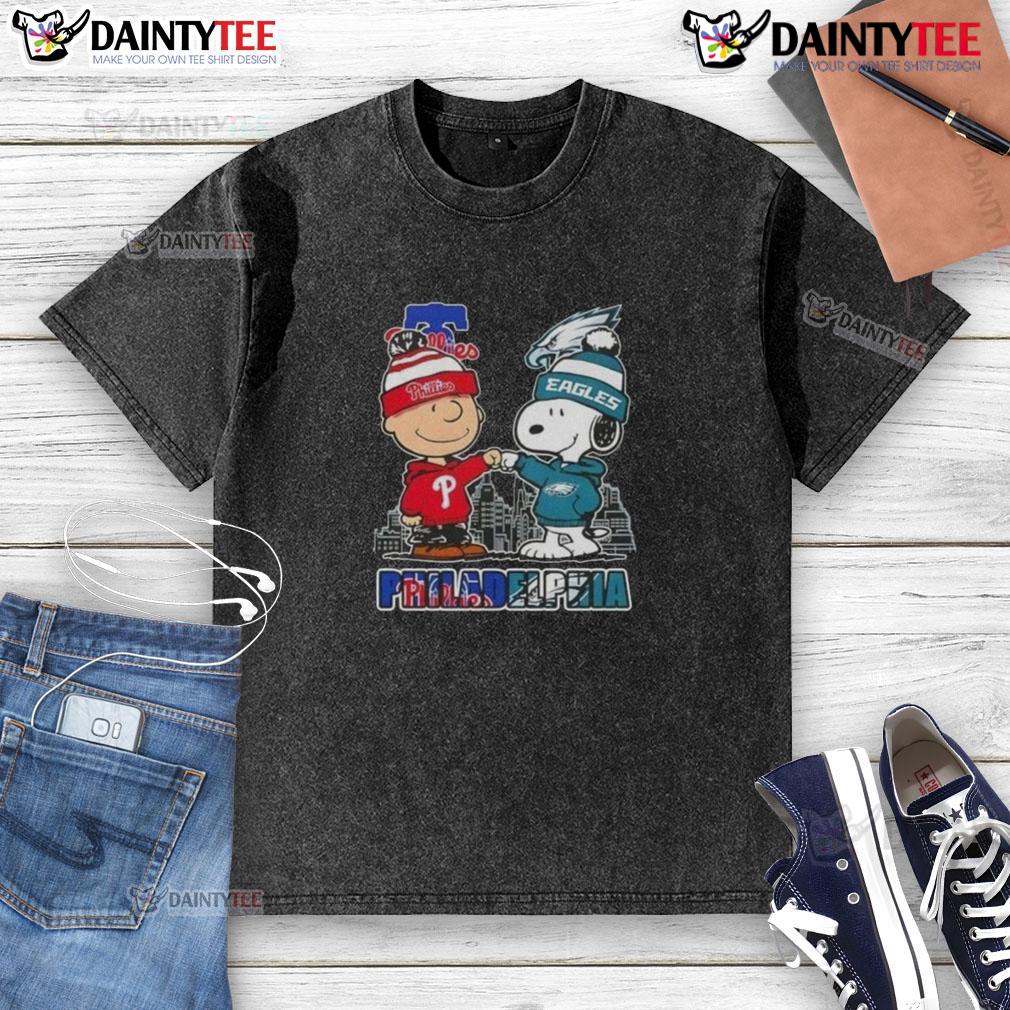 Cute Snoopy And Charlie Brown Philadelphia Sports Phillies X Eagles Skyline Washed T-Shirt Alt Text: Cute Snoopy and Charlie Brown in Philadelphia sports Phillies and Eagles skyline washed t-shirt design
