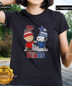 Alt Text: Cute Snoopy and Charlie Brown graphic on a Texas Tech Red Raiders vs. Dallas Cowboys skyline ladies tee shirt.