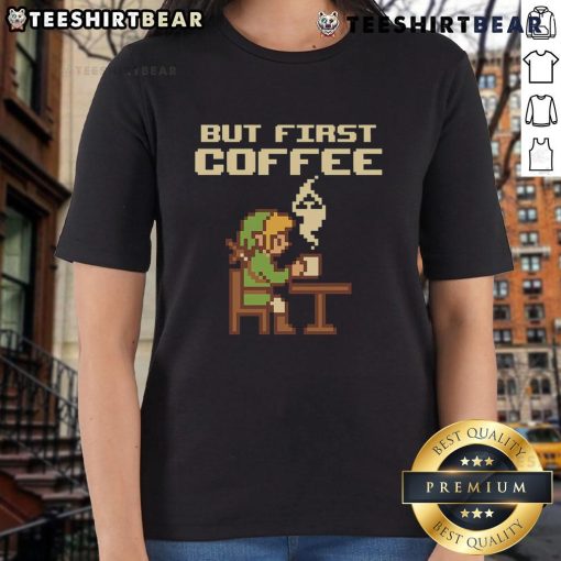 Funny 'But First Coffee' tee featuring retro Zelda pixel art for gamers, perfect for ladies who love gaming fashion.