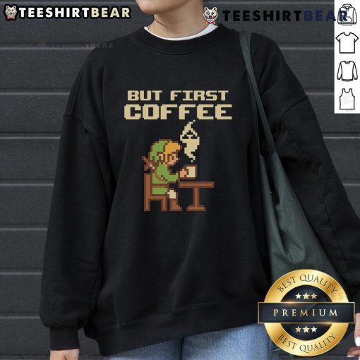 Funny 'But First Coffee' sweatshirt featuring retro gamer pixel art inspired by The Legend of Zelda.