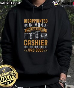 Funny cashier wearing 'God created this cashier' hoodie, looking disappointed at a customer in a grocery store.
