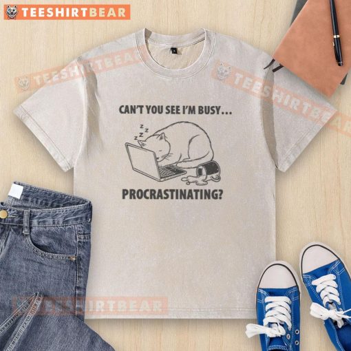 Funny cat with a humorous expression wearing a 'Can't You See I'm Busy Procrastinating' washed t-shirt.