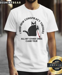 Funny cat on a T-shirt with the text 'I Need New Conspiracy Theories All My Other Ones Came True' for cat lovers.