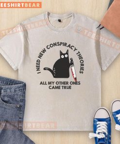 Funny cat graphic on a washed t-shirt, captioned I Need New Conspiracy Theories All My Other Ones Came True.
