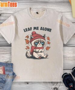 Funny cat on a leaf with a Leaf Me Alone caption, featured on a fall-themed washed t-shirt for cozy autumn vibes.