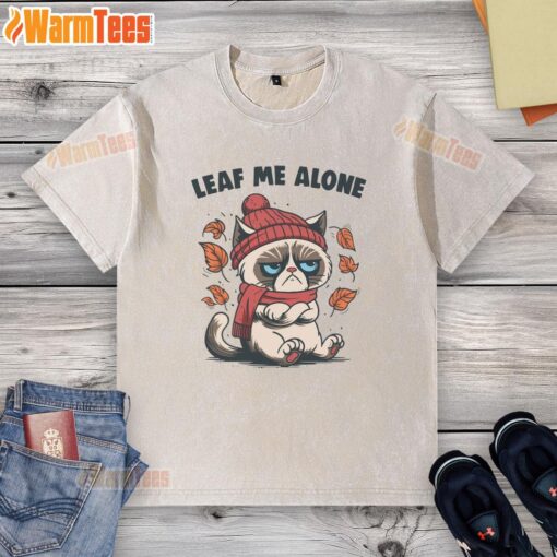 Funny cat on a leaf with a Leaf Me Alone caption, featured on a fall-themed washed t-shirt for cozy autumn vibes.