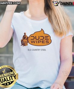 Alt Text: Humorous dude wipes an old country stool while wearing a ladies' tee, showcasing a funny and quirky moment.