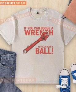 Funny 'If You Can Dodge A Wrench, You Can Dodge A Ball' washed t-shirt design showcasing humor and playful sports theme.