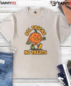 Funny pumpkin graphic on a washed t-shirt for Halloween, featuring 'All Tricks No Treats' design.