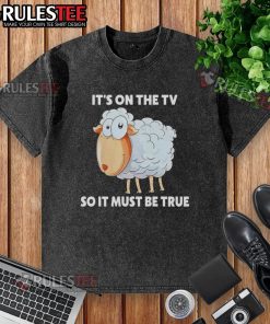 Funny sheep graphic on 'It's on the TV, so it must be true' washed t-shirt, perfect for humor and casual wear.