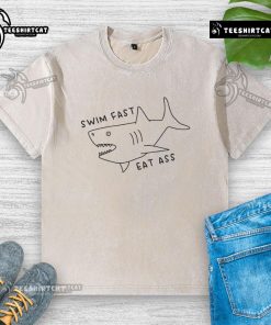 Funny Swim Fast Eat Ass Shark Washed T-Shirt featuring a playful shark graphic and humorous text, perfect for beachwear.