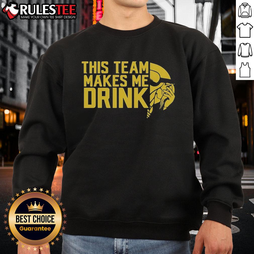 Funny This Team Makes Me Drink Minnesota Vikings Logo Sweatshirt Alt Text: Funny Minnesota Vikings logo sweatshirt that says 'This Team Makes Me Drink', perfect for fans and game day wear.