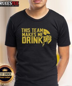 Funny Minnesota Vikings logo T-shirt that says 'This Team Makes Me Drink' perfect for fans and game day attire.