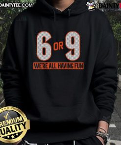 Group of friends wearing 'Good 6 or 9 We're All Having Fun' hoodies, enjoying a vibrant outdoor gathering.