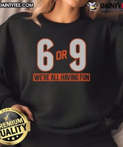 Group wearing 'Good 6 or 9 We're All Having Fun' sweatshirt, enjoying a lively outdoor gathering with smiles and laughter.
