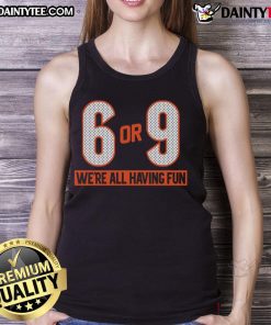 Group of friends wearing 'Good 6 or 9 We're All Having Fun' tank tops, enjoying a sunny day outdoors.