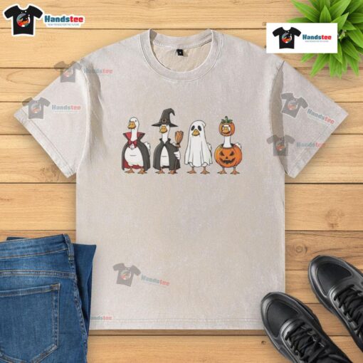 Good geese dressed up in Halloween costumes on a washed t-shirt, perfect for festive apparel and seasonal fun.