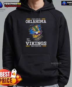 Good I May Live In Oklahoma But I'm A Minnesota Vikings Fan Forever Hoodie featuring team colors and logo.