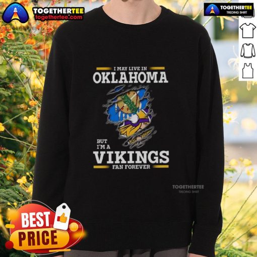 Good I May Live In Oklahoma But I'm A Minnesota Vikings Fan Forever sweatshirt showcasing team pride and comfort.