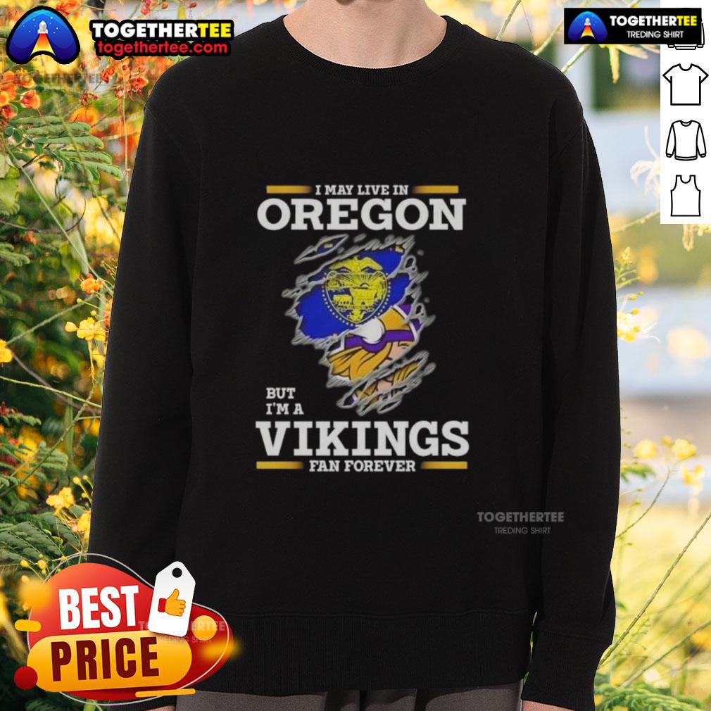 Good I May Live In Oregon But I'M A Minnesota Vikings Fan Forever Sweatshirt Good I May Live In Oregon But I'm A Minnesota Vikings Fan Forever Sweatshirt showcasing team pride and cozy style.