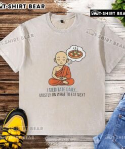 Person meditating daily in a washed t-shirt, focusing on healthy eating choices and mindfulness practices.