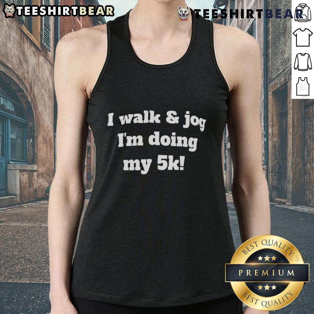 Good I Walk And Jog I'M Doing My 5K Tank Top Runner wearing a 'Good I Walk and Jog I'm Doing My 5K' tank top during a 5K race, showcasing fitness and motivation.