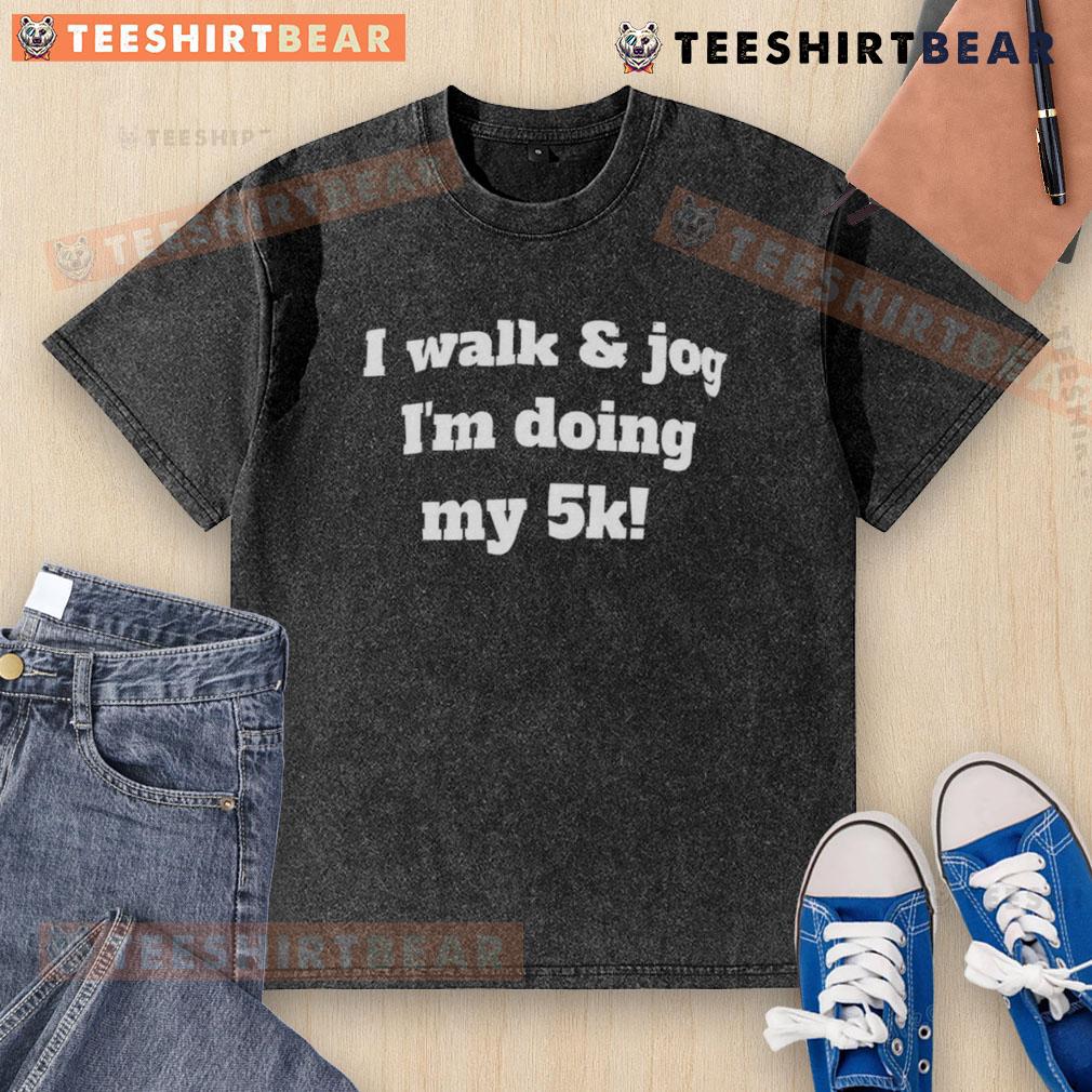 Good I Walk And Jog I'M Doing My 5K Washed T Shirt Person wearing a washed t-shirt that says 'Good I Walk and Jog' during a 5K run, showcasing fitness and motivation.