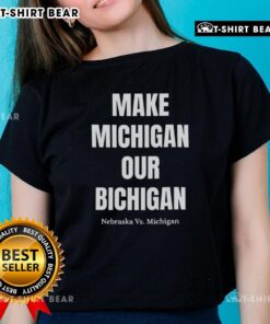 Alt Text: Nebraska vs Michigan ladies tee featuring 'Good Make Michigan Our Bichigan' design, perfect for game day style.