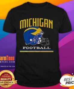 Alt Text: Vintage Michigan Wolverines football helmet graphic on a classic T-shirt, perfect for fans of college football.