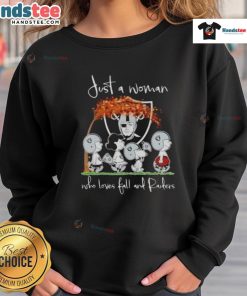 Woman wearing a Las Vegas Raiders sweatshirt, enjoying fall vibes with good peanuts in a cozy setting.