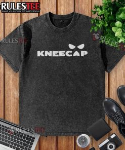 Sami Zayn wearing a stylish kneecap washed t-shirt, showcasing a modern casual look in a vibrant setting.