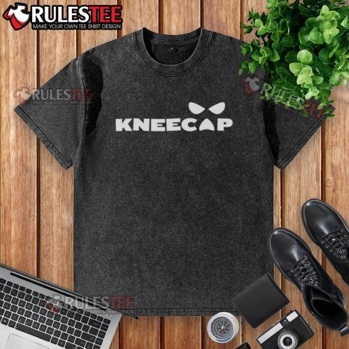 Sami Zayn wearing a stylish kneecap washed t-shirt, showcasing a modern casual look in a vibrant setting.