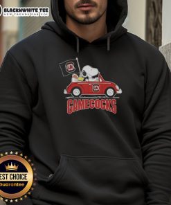 Alt Text: Snoopy driving a car wearing a South Carolina Gamecocks football hoodie, showcasing team spirit and fun.