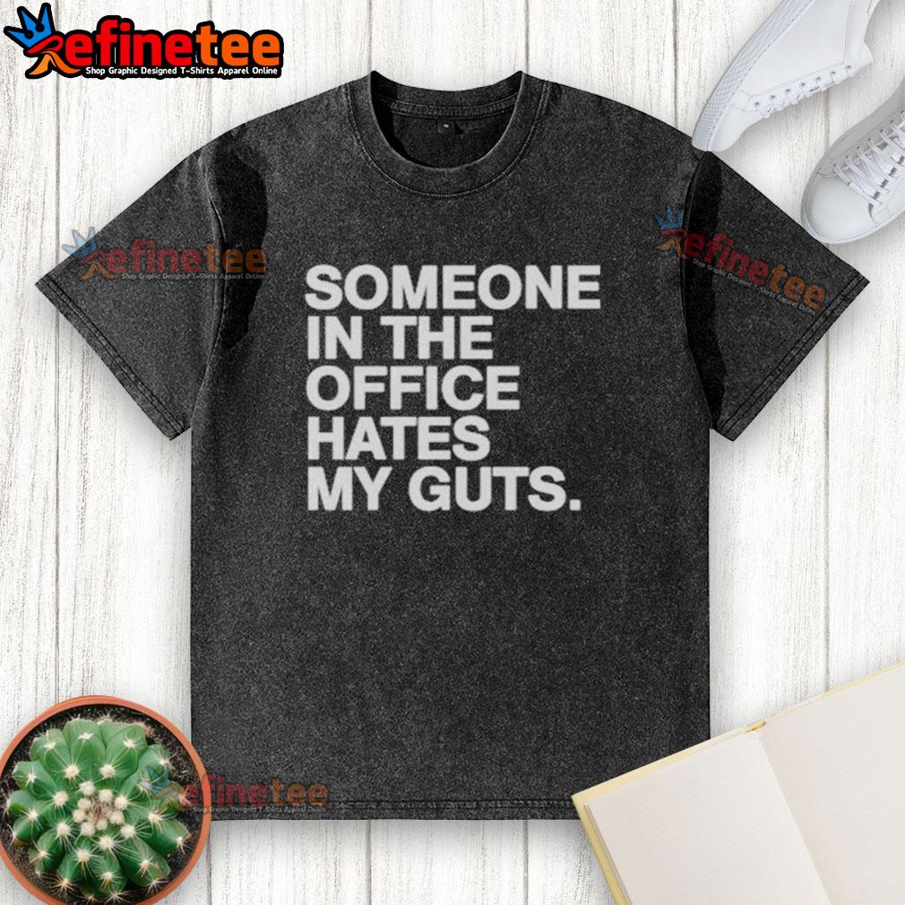 Good Someone In The Office Hates My Guts Washed T Shirt Good Someone In The Office Hates My Guts washed t-shirt displayed on a hanger in a modern office setting.