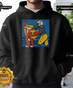 Good Teair Tart slapping Travis Kelce wearing a stylish hoodie, capturing a fun and playful moment.