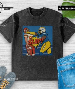 Good Teair Tart slapping Travis Kelce in a washed t-shirt, capturing a fun moment from pop culture.