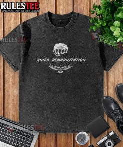 Alt Text: Good Tony Ferguson Shifa Rehabilitation washed t-shirt displayed on a hanger, showcasing its unique design and comfort.